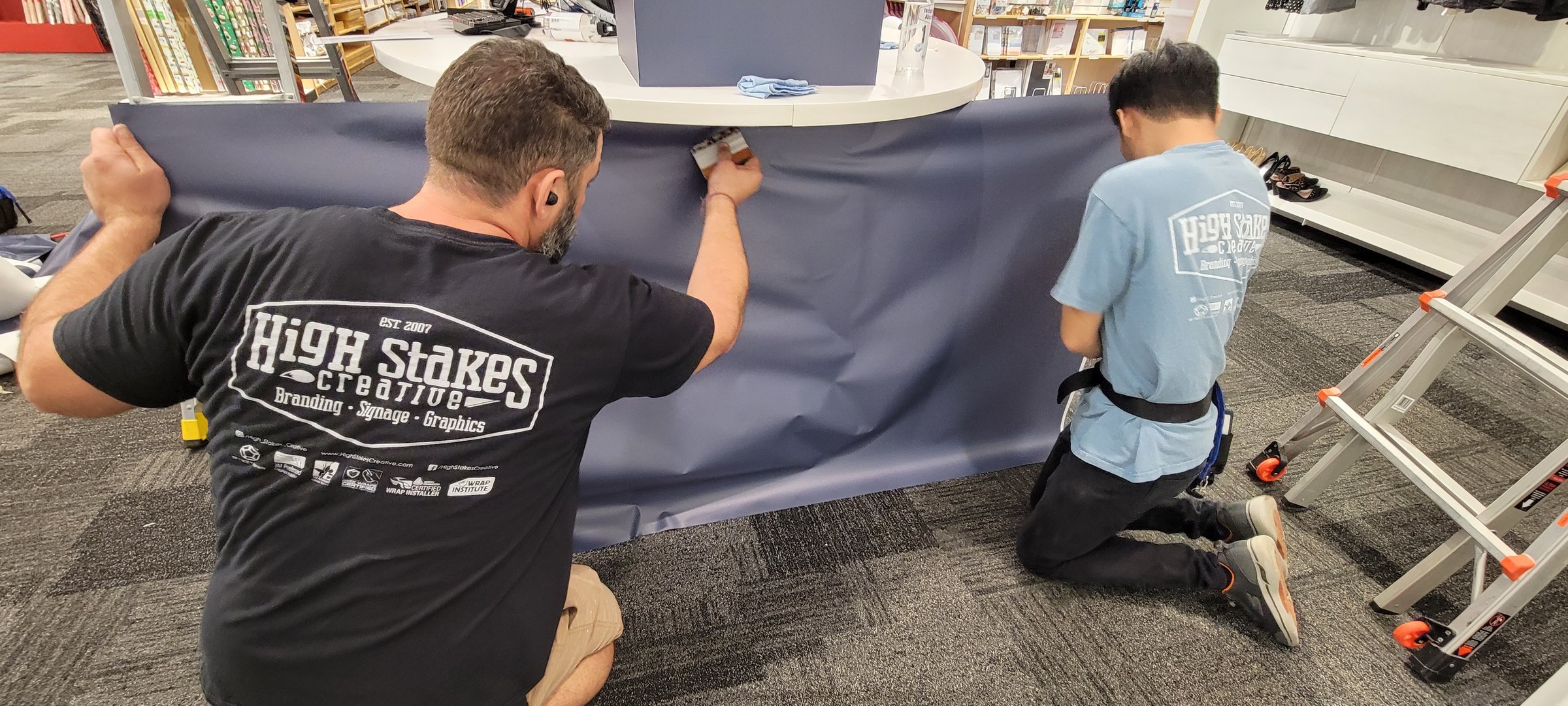 Installing Custom Spaces desk graphics, The Container Store, Alpharetta, GA, by High Stakes Creative