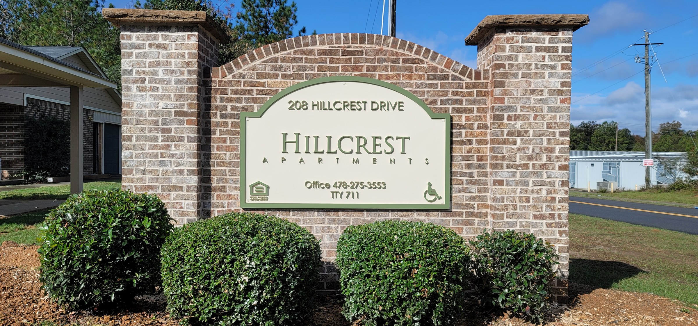 Brick monument with Hillcrest Apartments panel, 208 Hillcrest Drive, Hillcrest Apartments, by High Stakes Creative