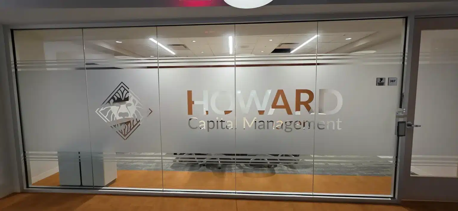 Frosted glass office branding with the Howard Capital Management logo, installed by High Stakes Creative