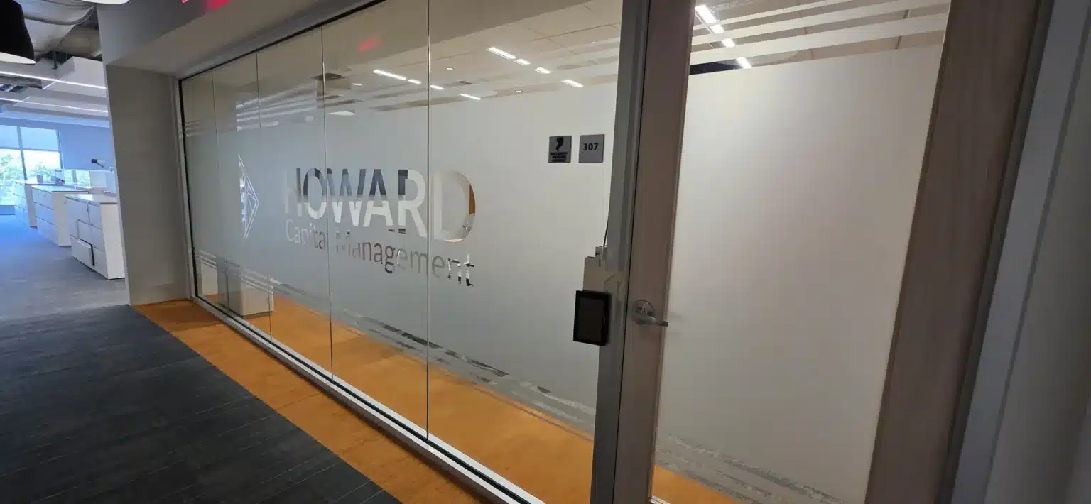 Frosted glass office branding with the Howard Capital Management logo, installed by High Stakes Creative
