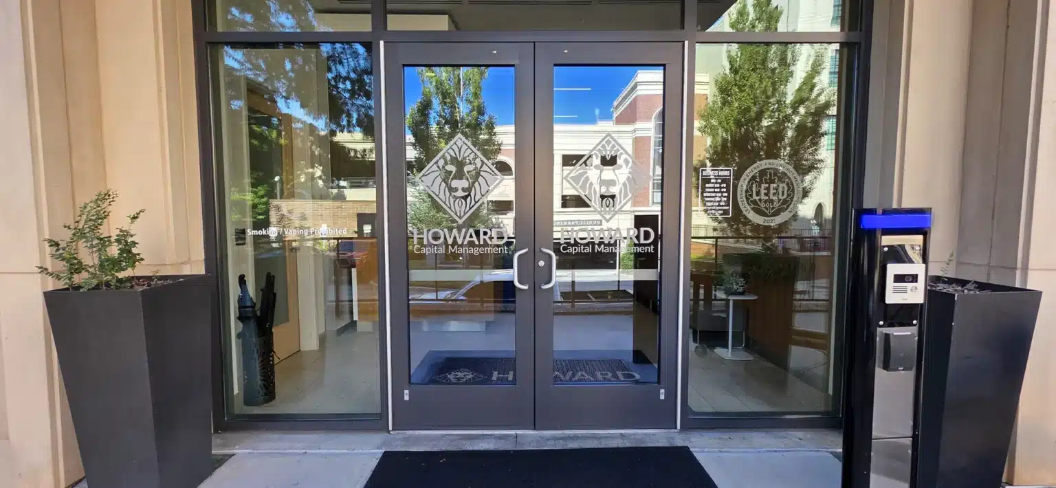 Frosted glass office branding with the Howard Capital Management logo, installed by High Stakes Creative