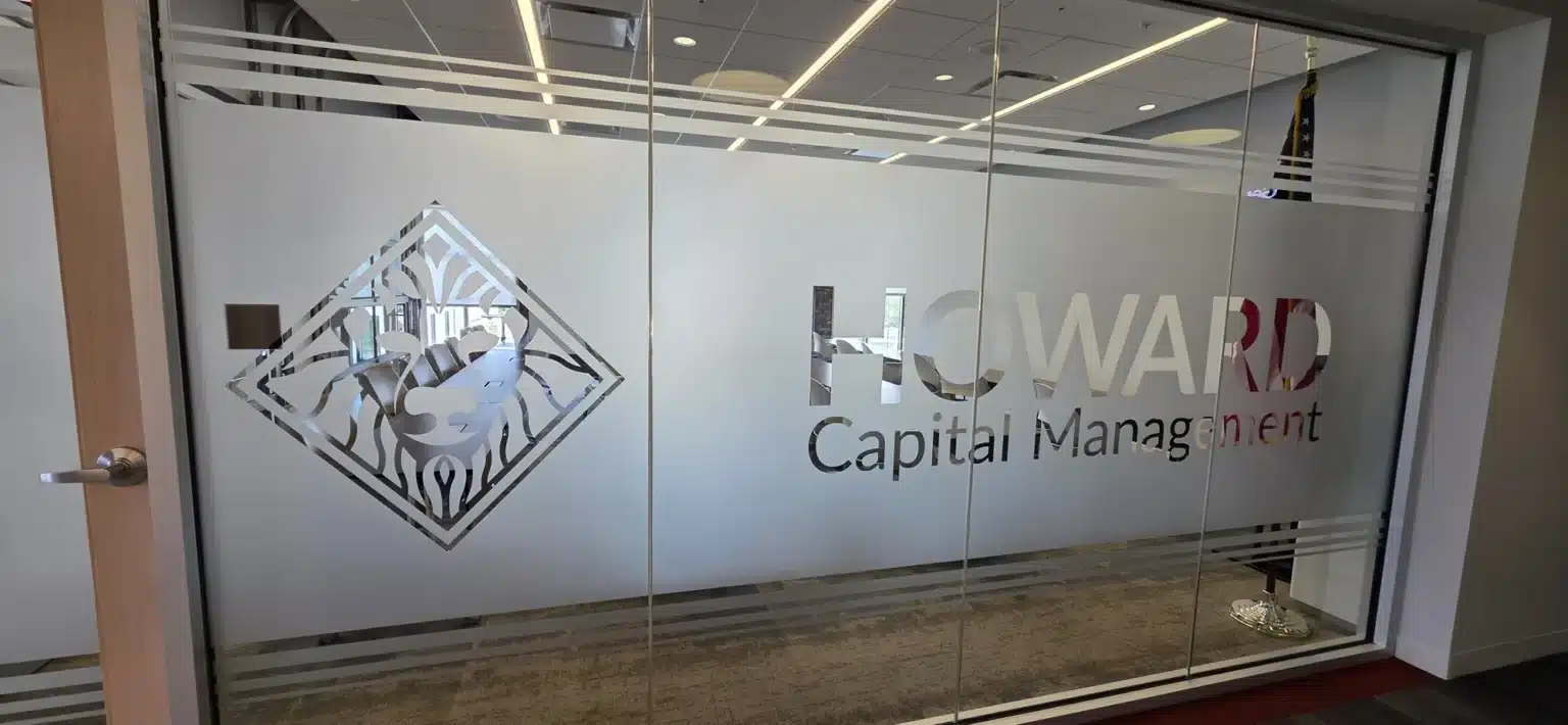 Frosted glass office branding with the Howard Capital Management logo, installed by High Stakes Creative