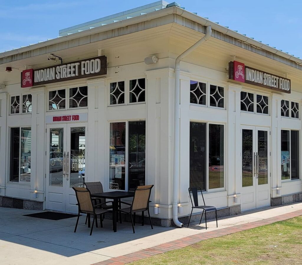 Corner view of restaurant pavilion with two Indian Street Food signs, Indian Street Food, by High Stakes Creative