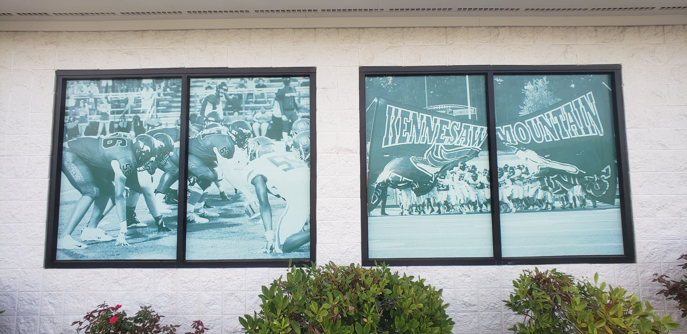 Perforated/printed window graphics with football photos and KM mustang logo at arched scho, Kennesaw Mountain, Kennesaw, GA, by High Stakes Creative