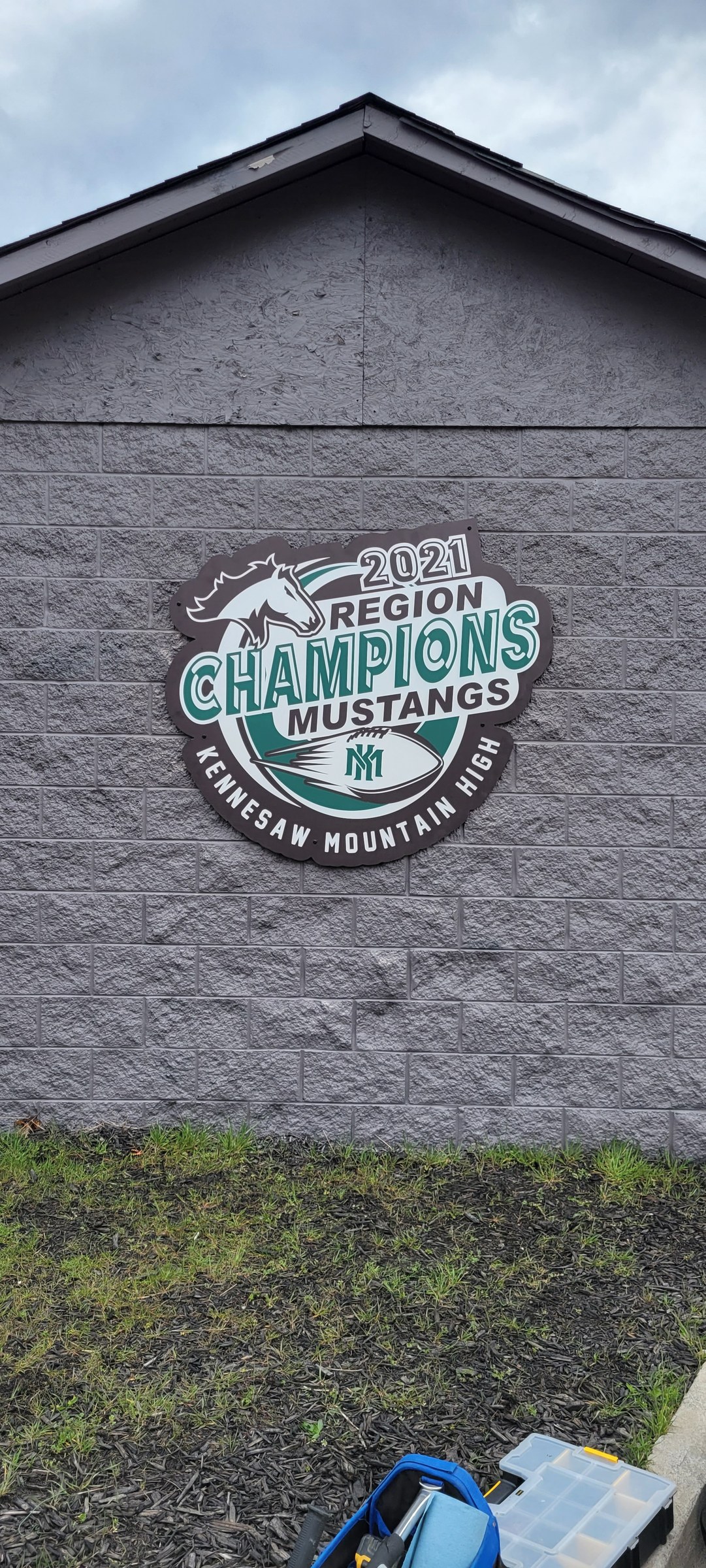 2021 Region Champions Mustangs graphic on block building, Kennesaw Mountain High School, Kennesaw, GA, by High Stakes Creative