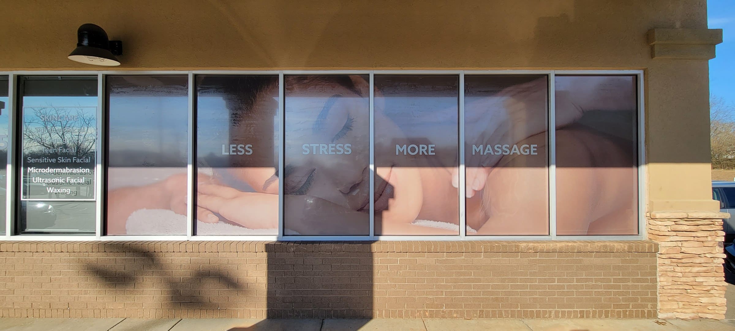 Storefront window graphics: door hours/logo decal, price window and full-height lifestyle , LaVida Massage, Canton, GA, by High Stakes Creative