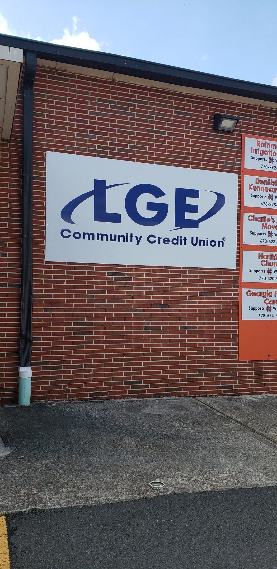 LGE Community Credit Union panel sign on brick building with sponsor panels, LGE Community Credit Union, by High Stakes Creative