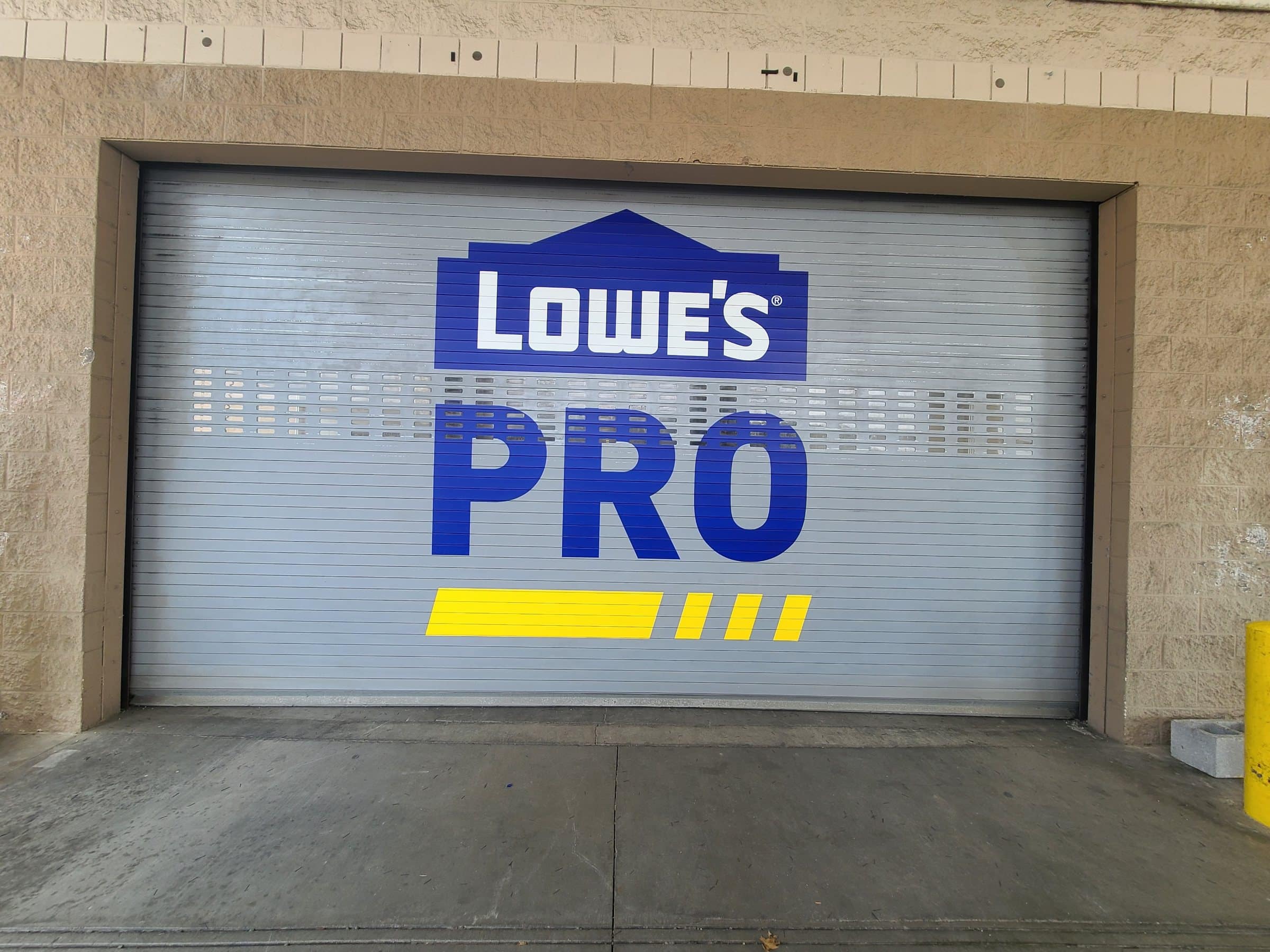 Lowe's PRO roll-up door graphic at contractor entrance, Lowe's, Kennesaw, GA, by High Stakes Creative