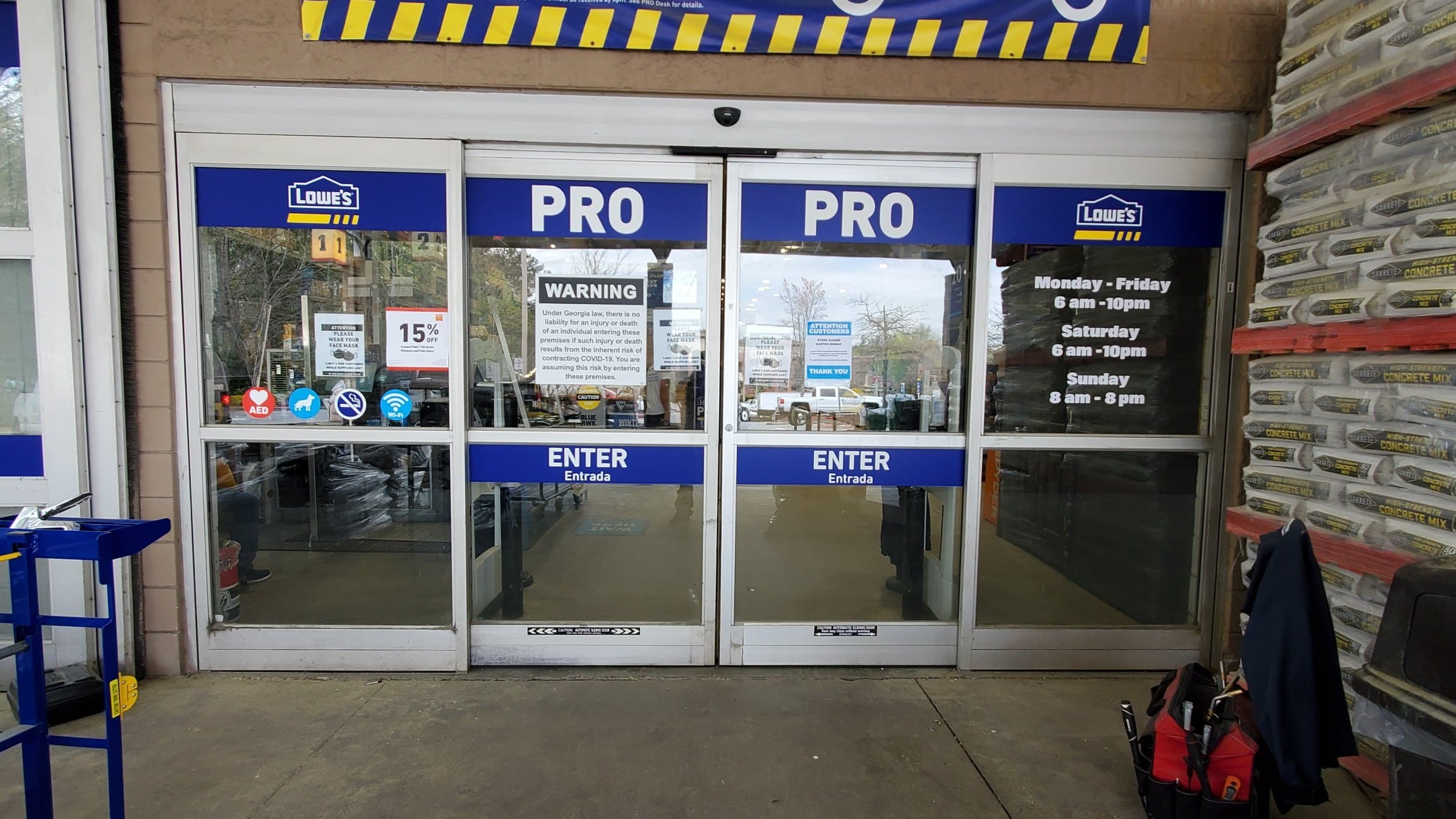PRO entry door graphics and hours, Lowe's, Alpharetta, GA, by High Stakes Creative