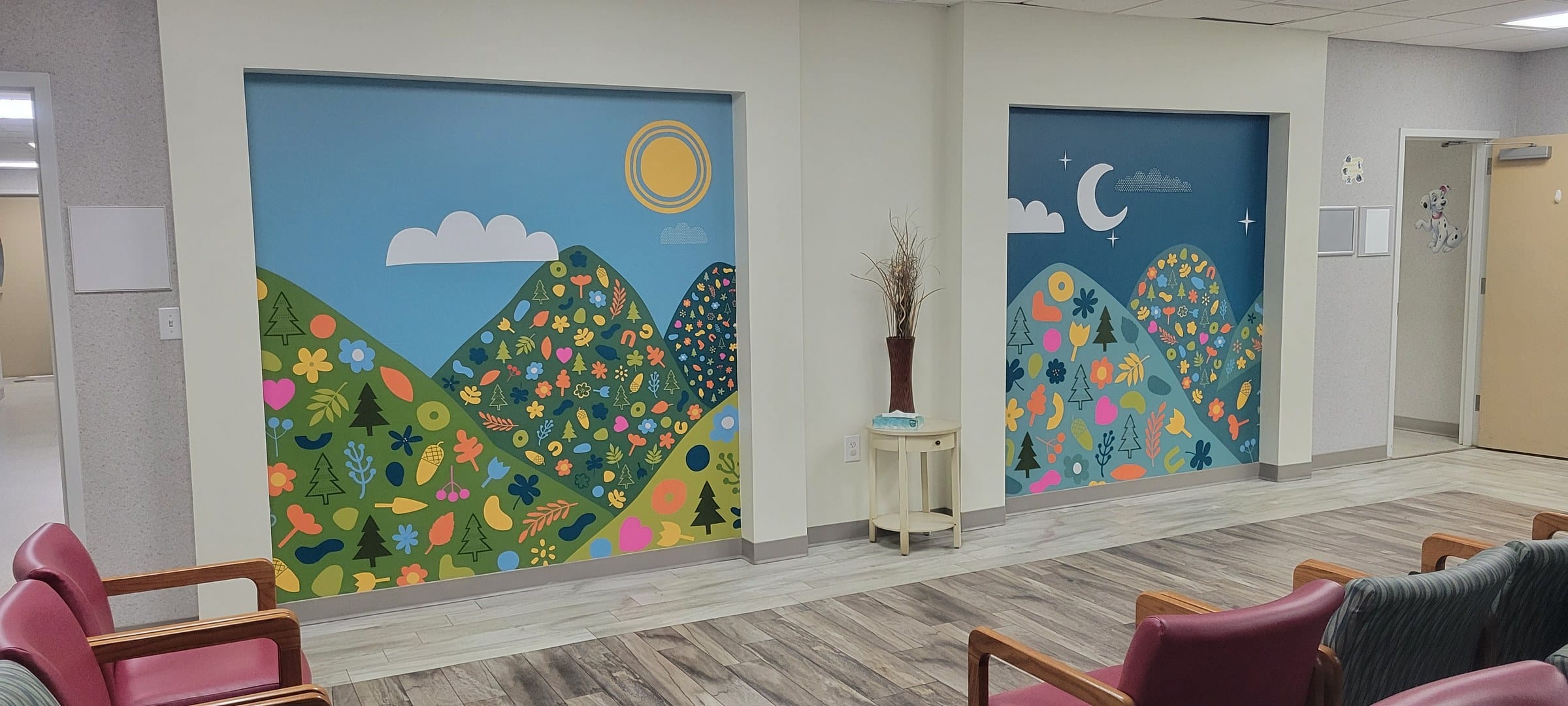 Illustrated mountain/flower/sun wall murals in office rooms and a framed lobby wall (day a, by High Stakes Creative