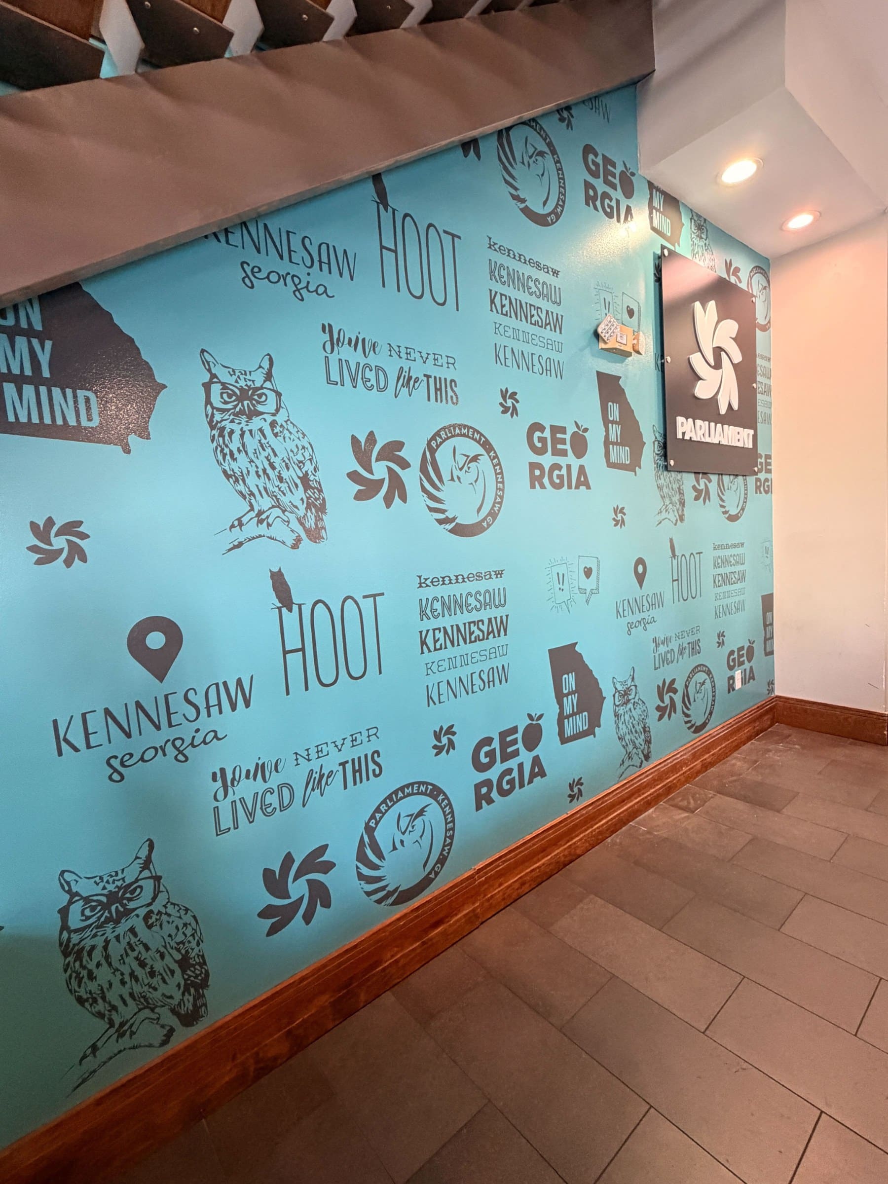Lobby wall graphic and logo panel, Parliament, Kennesaw, GA, by High Stakes Creative