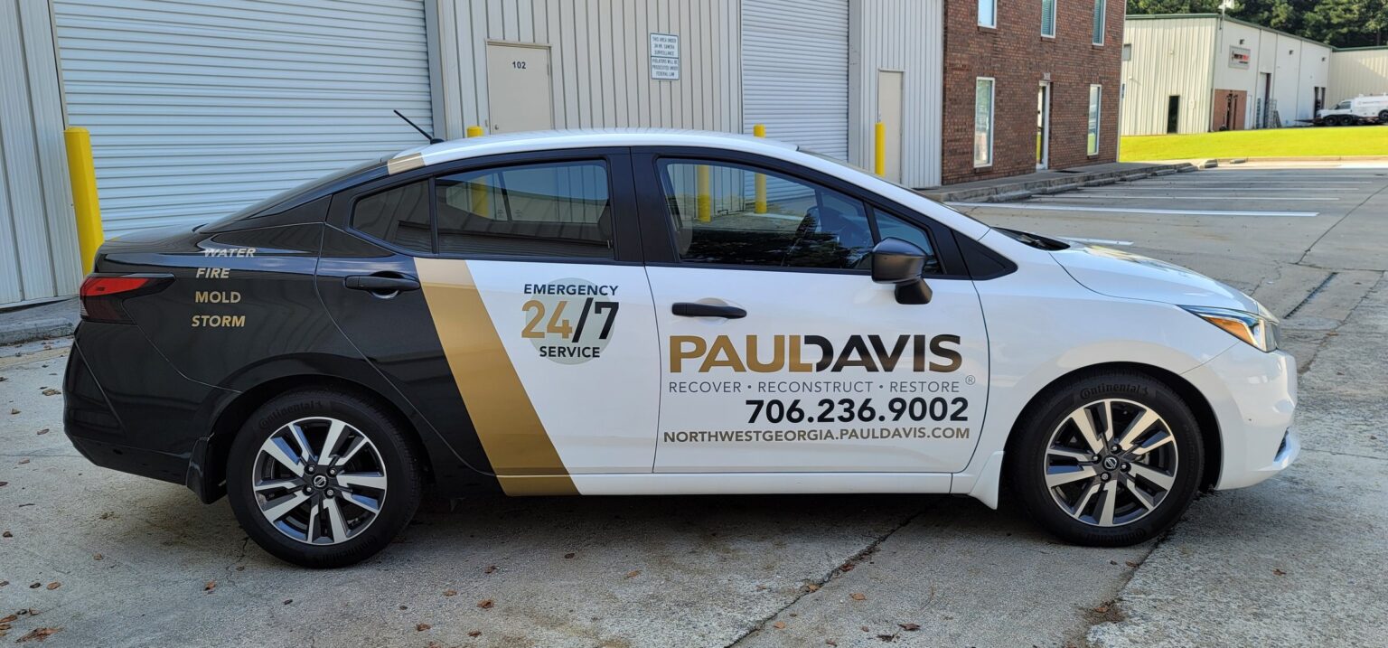 Partial wrap on Nissan Versa, passenger side, Paul Davis Restoration, by High Stakes Creative