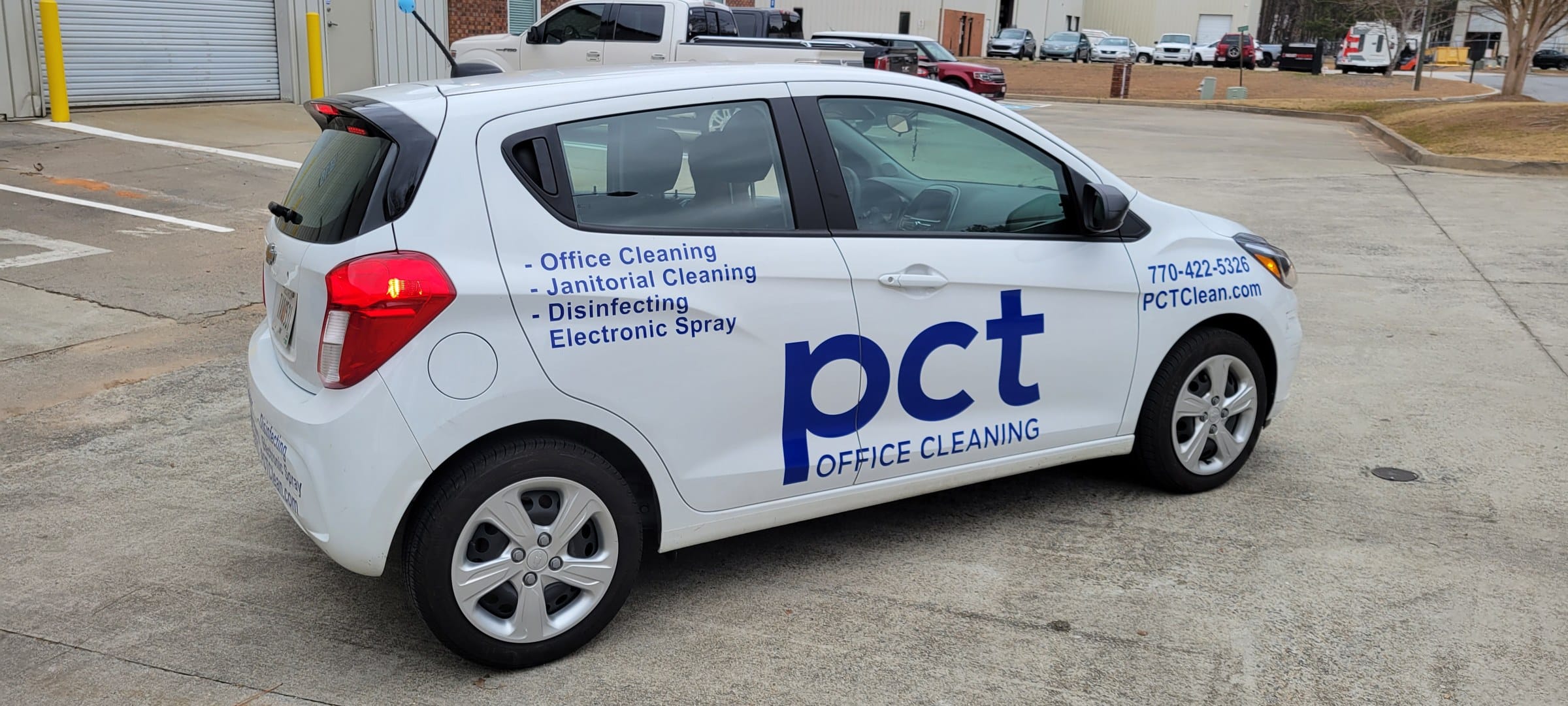 PCT Office Cleaning logo and service list on a white Chevy Spark, PCT Office Cleaning, by High Stakes Creative