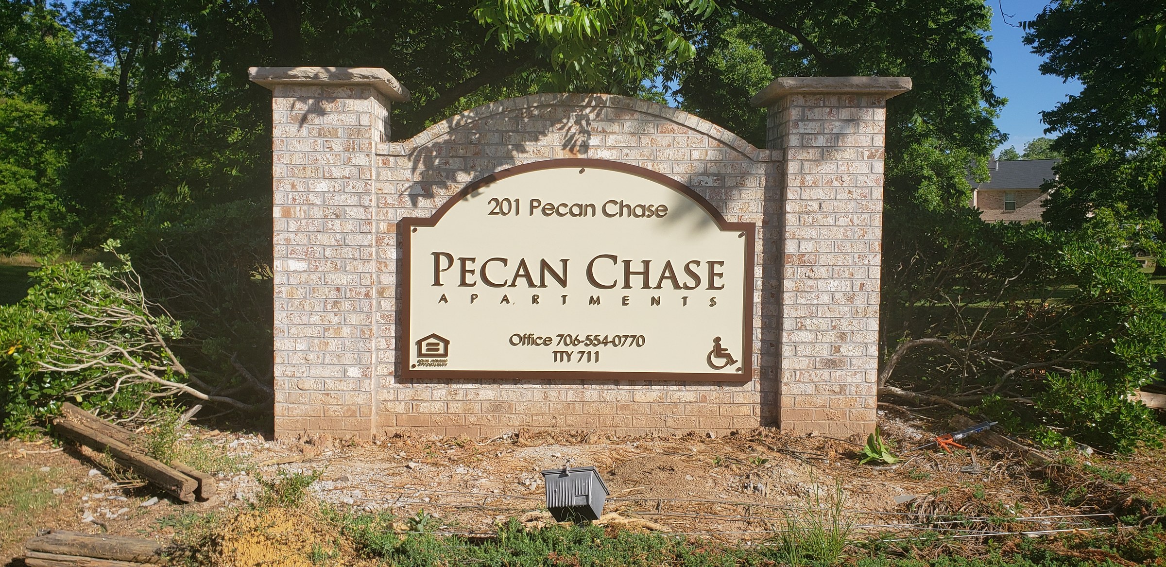 Monument, wider angle with new landscaping, Pecan Chase Apartments, by High Stakes Creative