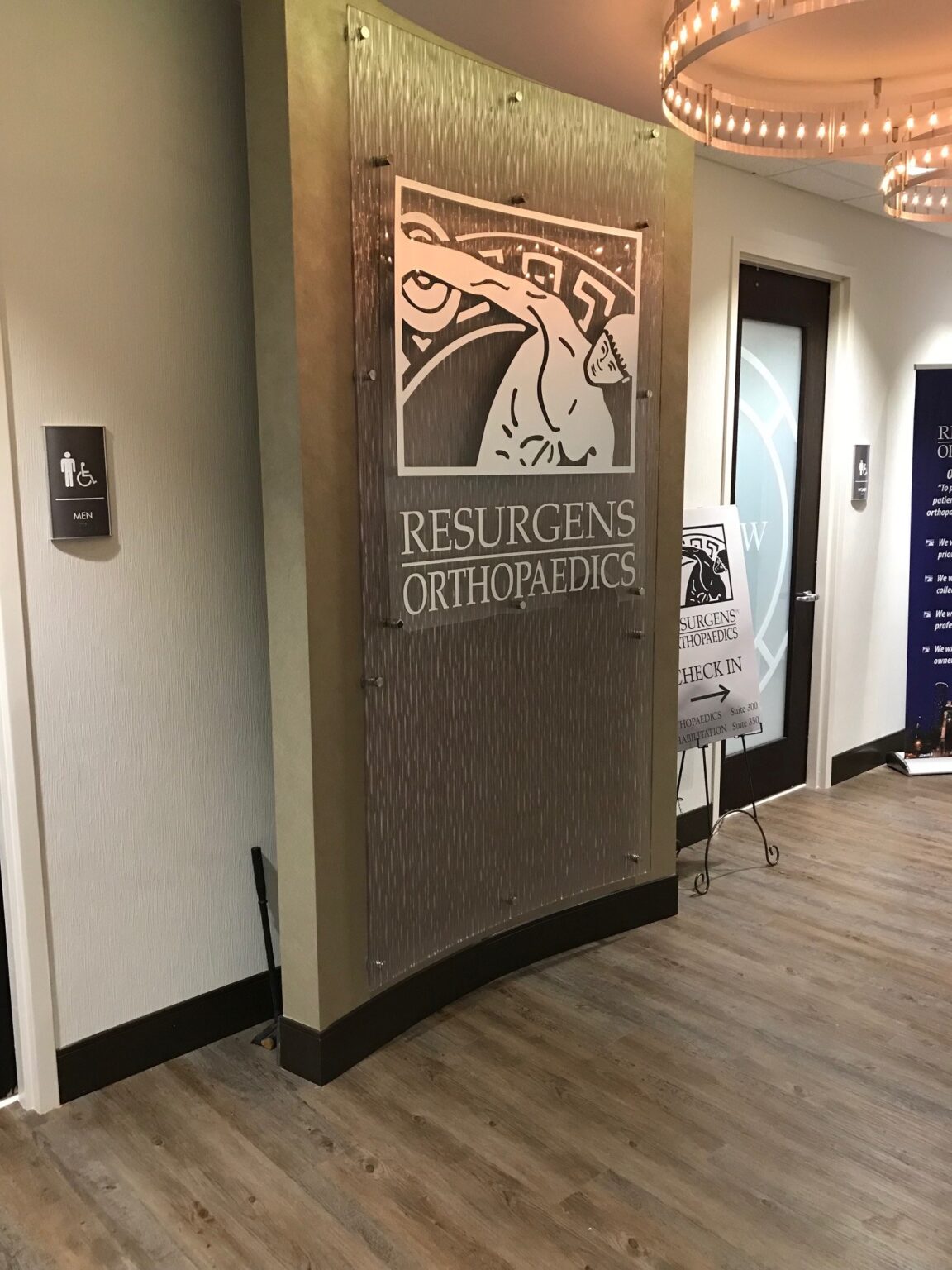 Curved textured lobby feature panel with standoff-mounted logo panel, Resurgens Orthopaedics, by High Stakes Creative