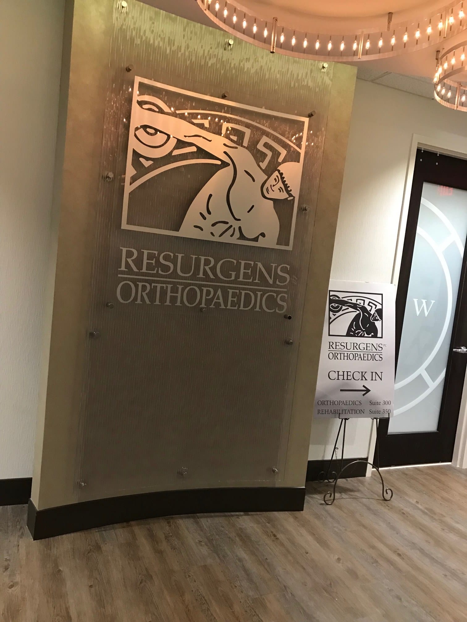 Curved textured lobby feature panel with standoff-mounted logo panel, Resurgens Orthopaedics, by High Stakes Creative
