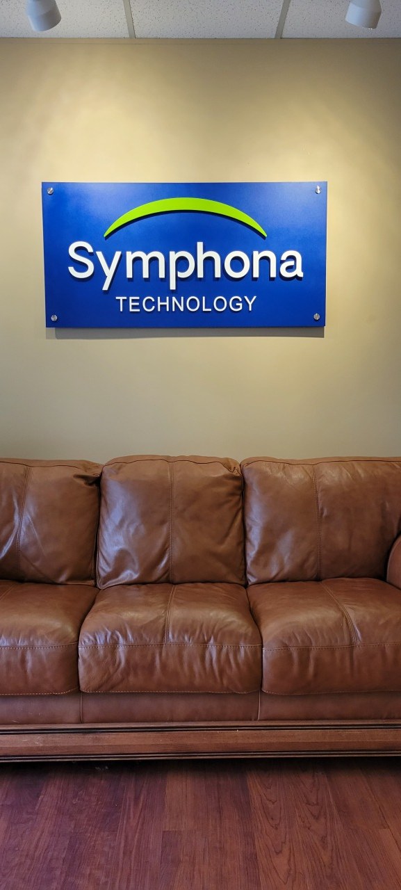 Lobby logo panel above sofa, Symphona Technology, by High Stakes Creative