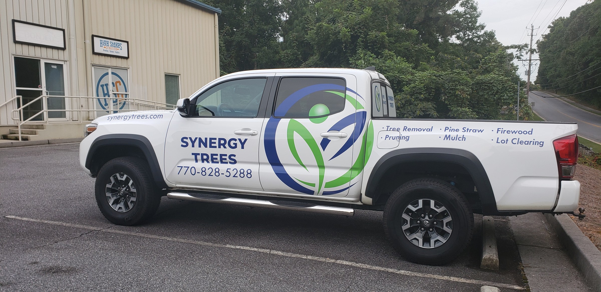 Passenger side Tacoma graphics with tree service list, Synergy Trees, by High Stakes Creative