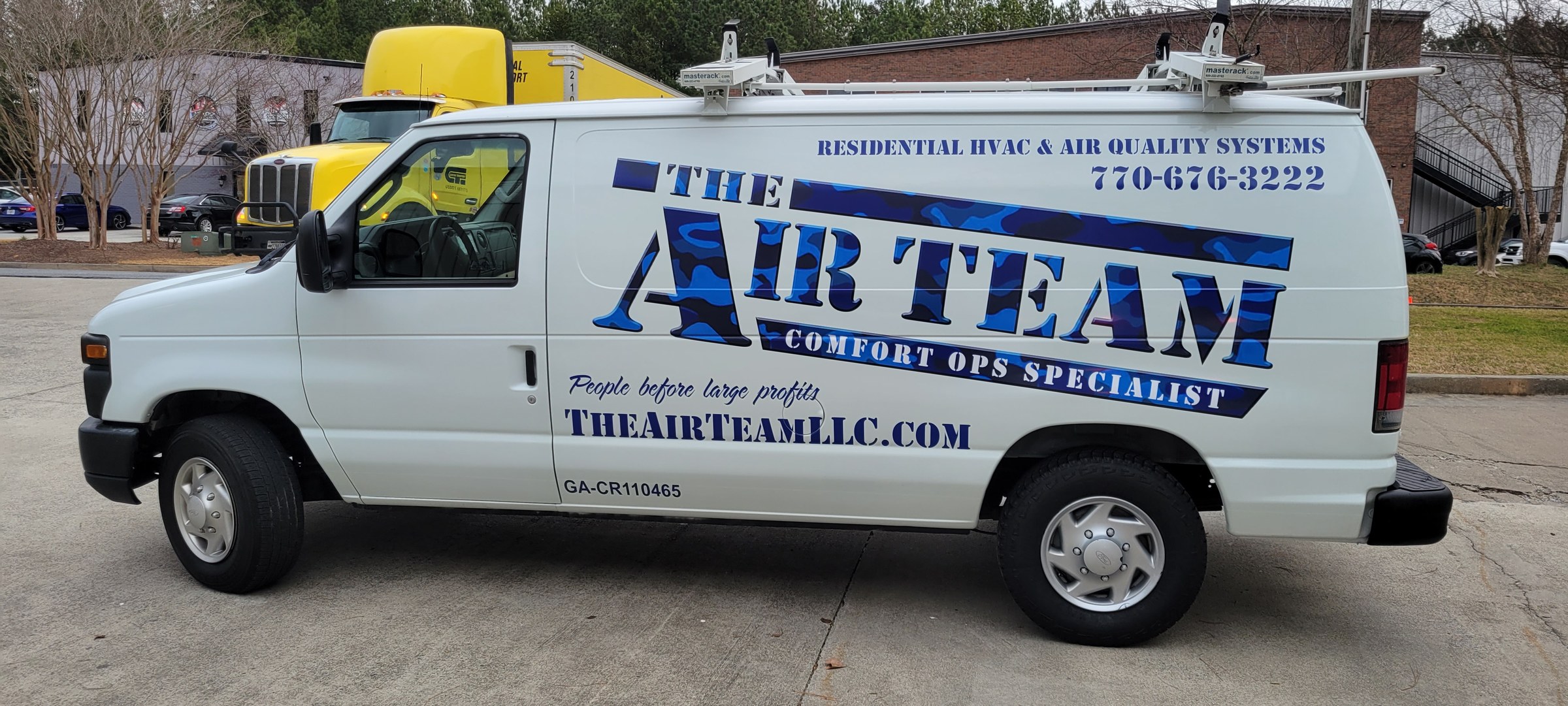 Logo, residential HVAC lettering and web/phone graphics on a white Ford E-series van, The Air Team, by High Stakes Creative