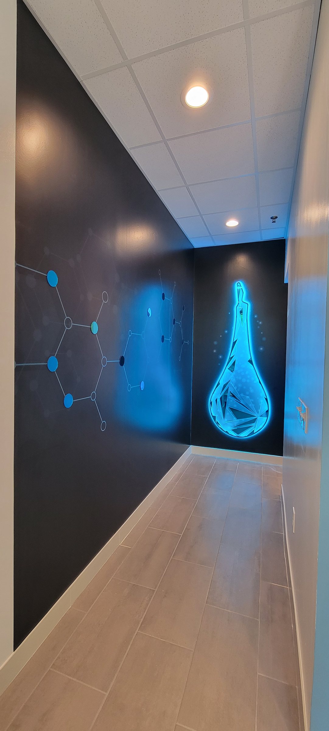 Hallway wall mural with glowing IV-drop graphic, The DRIPBaR, Atlanta, GA, by High Stakes Creative