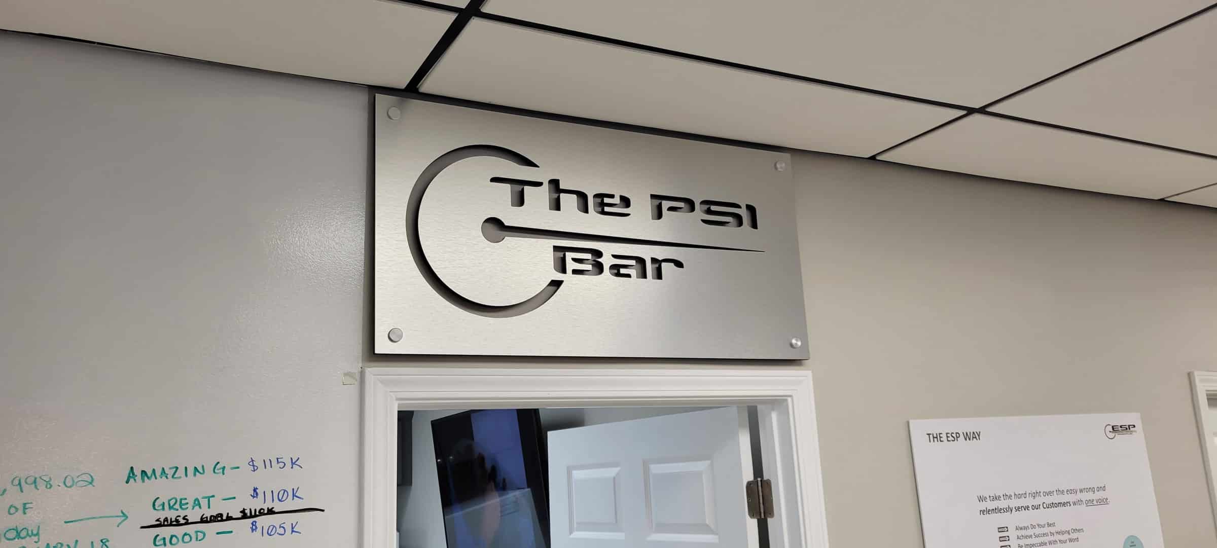 Brushed-metal look dimensional sign over doorway, The PSI Bar, by High Stakes Creative