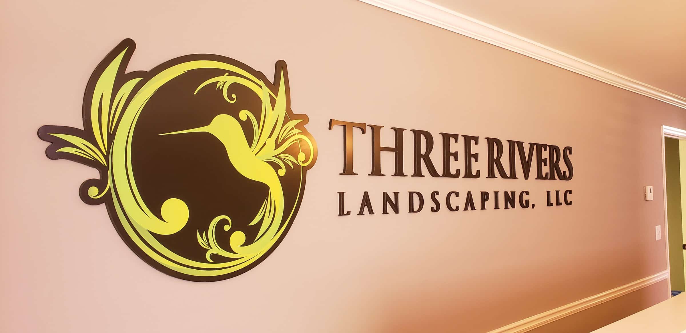 Dimensional hummingbird logo and lettering on stairwell/lobby wall, Three Rivers Landscaping, by High Stakes Creative