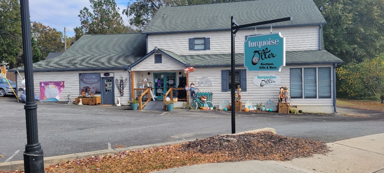 Sign with boutique building behind, Turquoise Otter, by High Stakes Creative