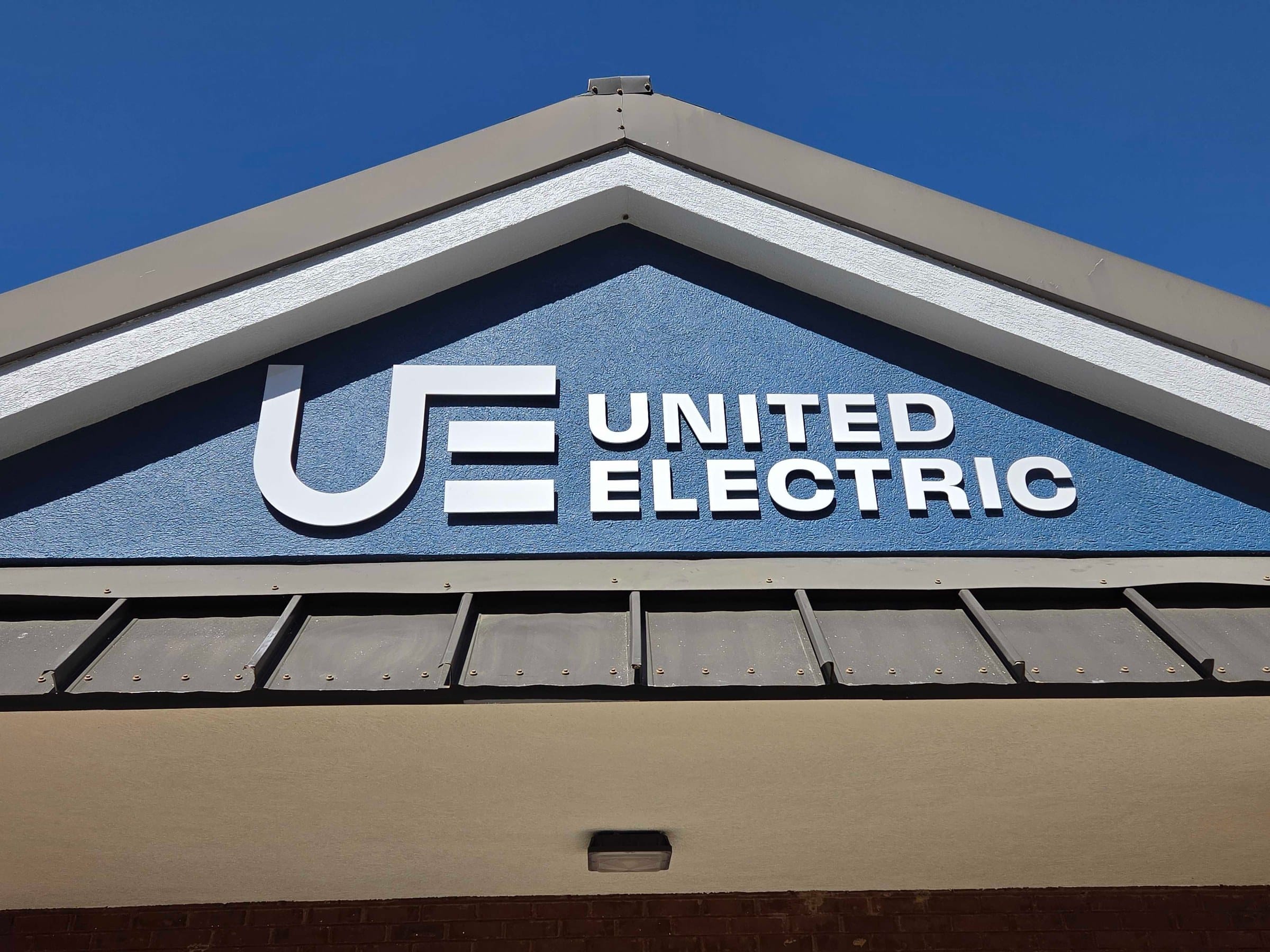Building logo sign on entry gable, United Electric, Marietta, GA, by High Stakes Creative