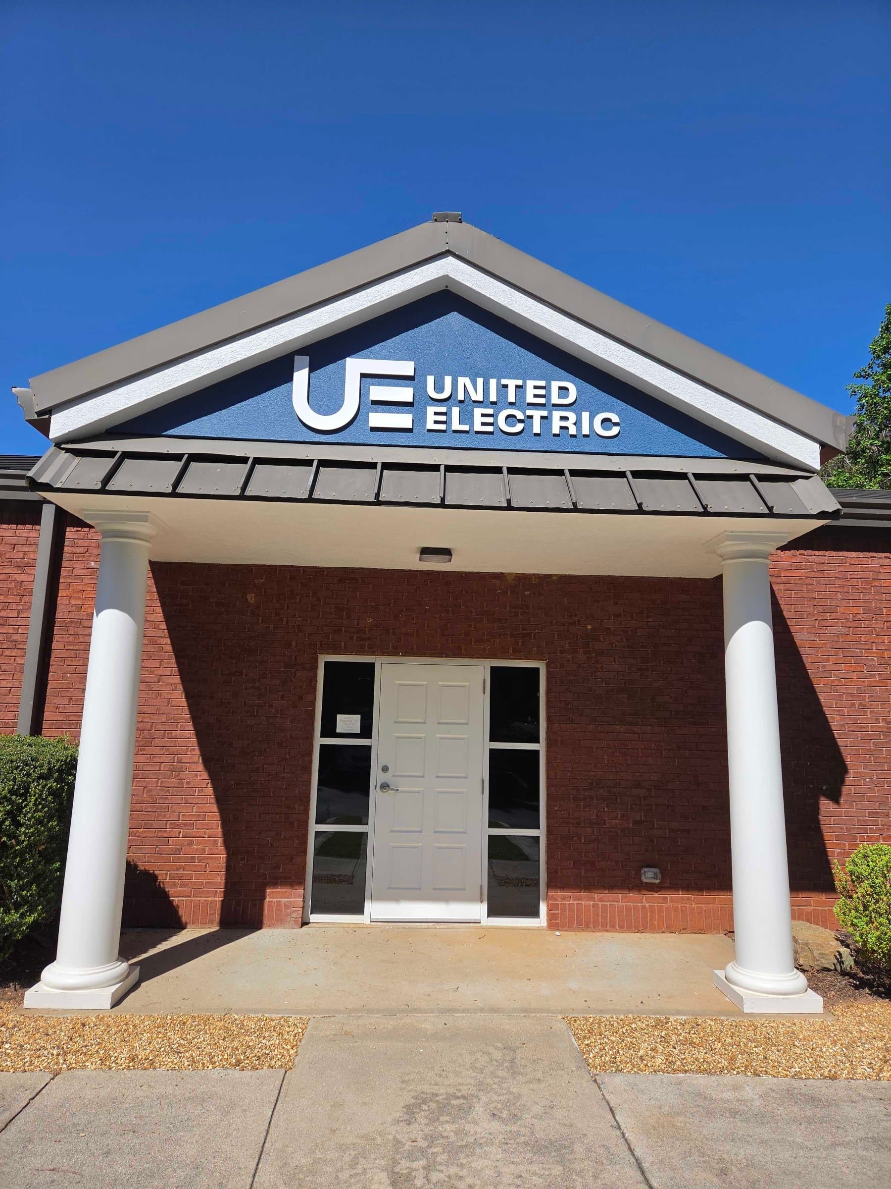 Building logo sign on entry gable, United Electric, Marietta, GA, by High Stakes Creative