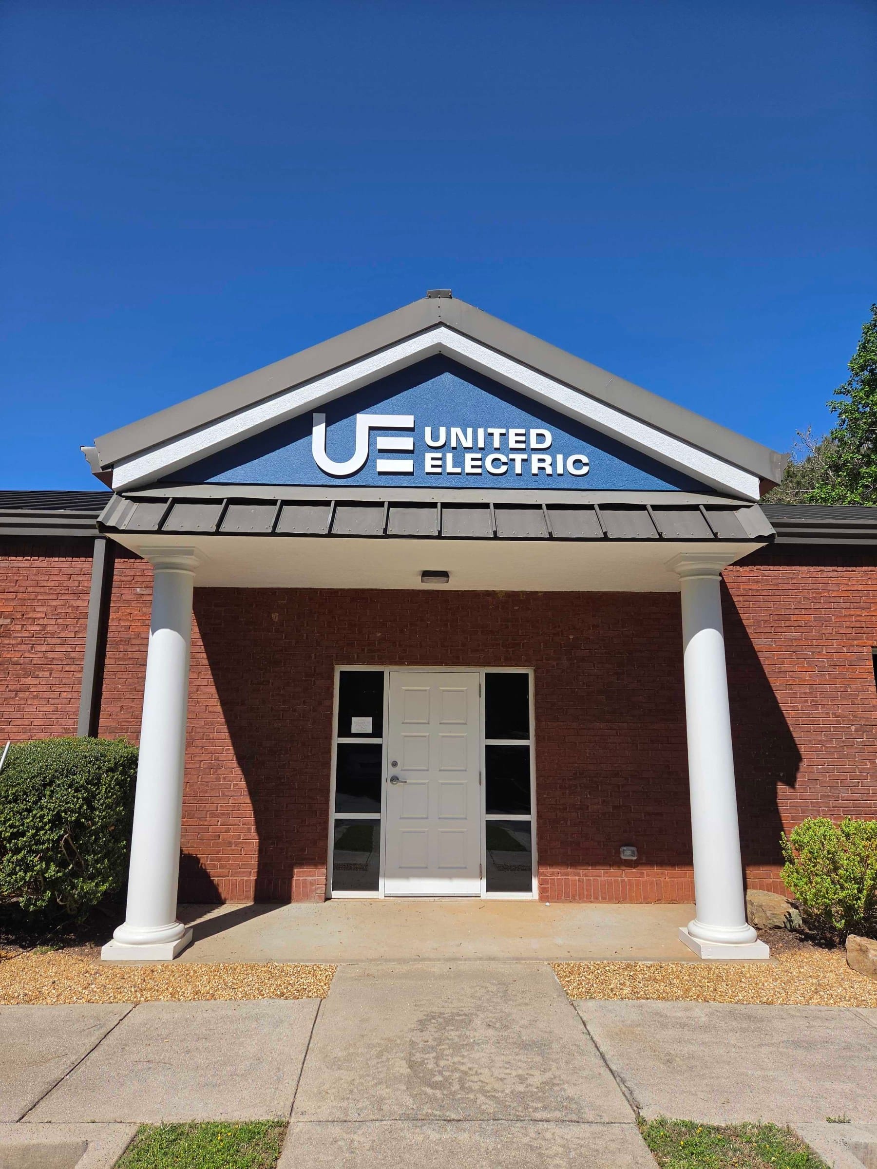 Building logo sign on entry gable, United Electric, Marietta, GA, by High Stakes Creative