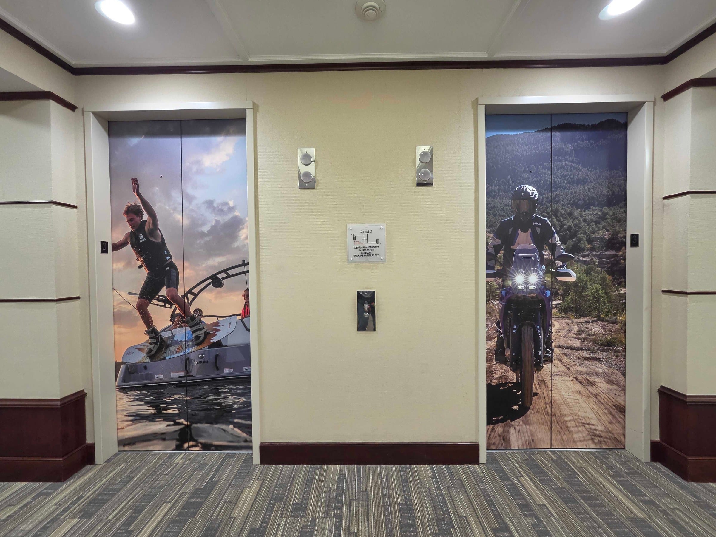 World map wall and elevator door wraps, Yamaha, Kennesaw, GA, by High Stakes Creative