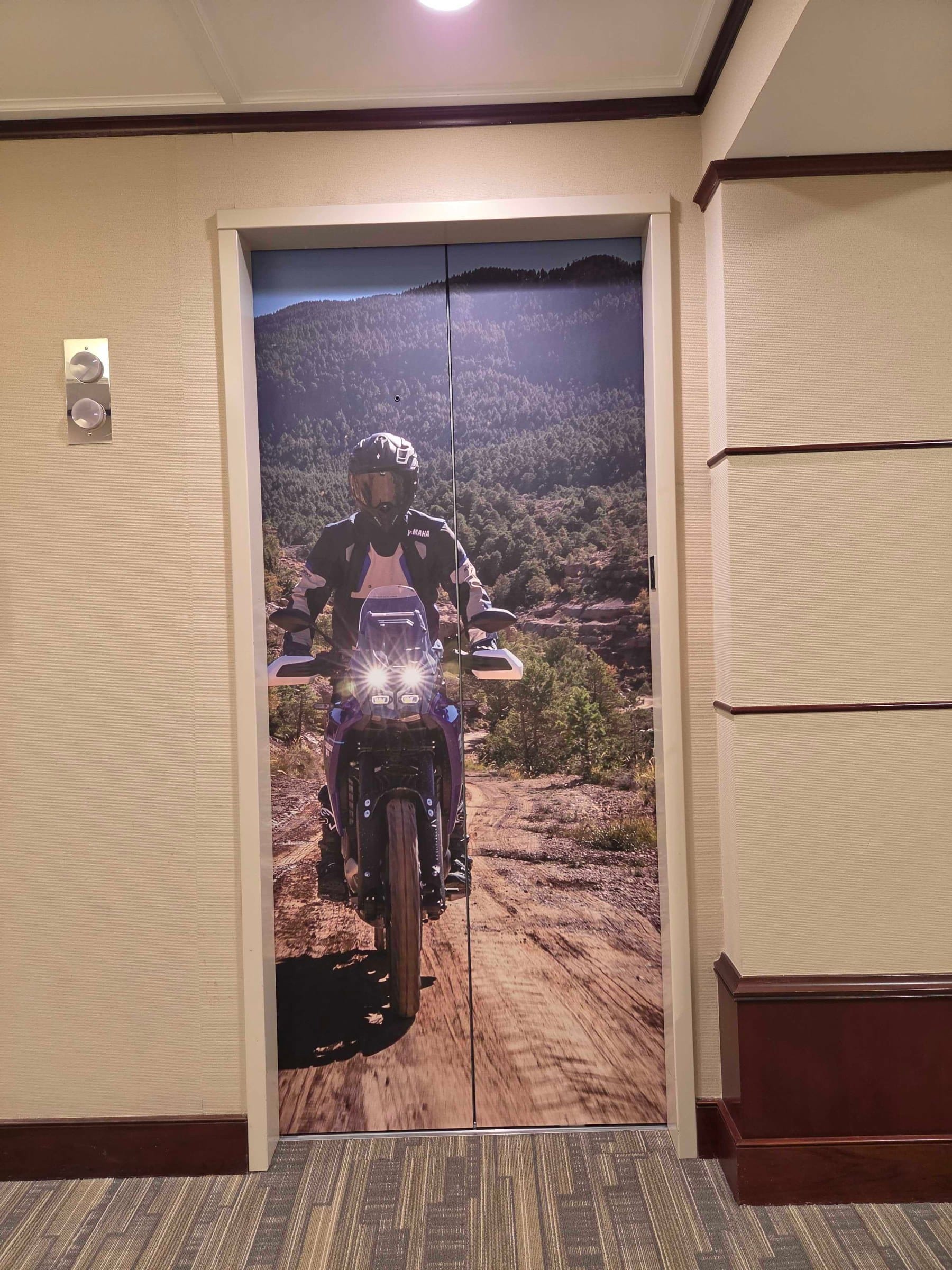 World map wall and elevator door wraps, Yamaha, Kennesaw, GA, by High Stakes Creative