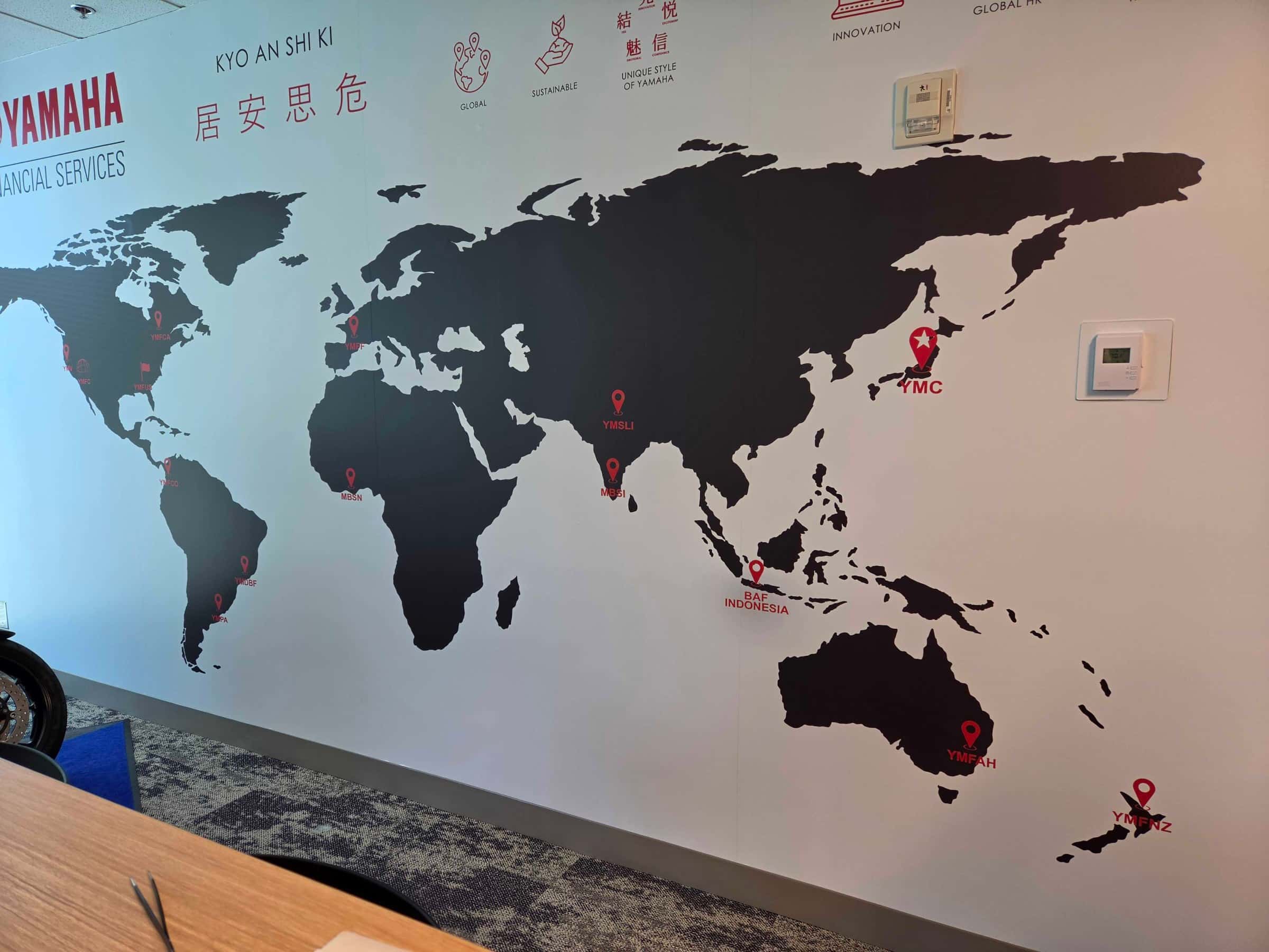 World map wall and elevator door wraps, Yamaha, Kennesaw, GA, by High Stakes Creative